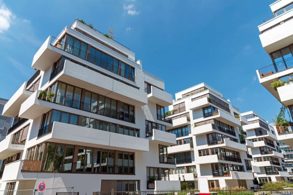 modern-white-townhouses-on-a-sunny-day-P4CDZLP-e1609136477183.jpg